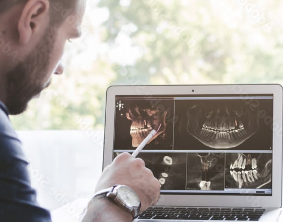 oral surgeon studying x-rays