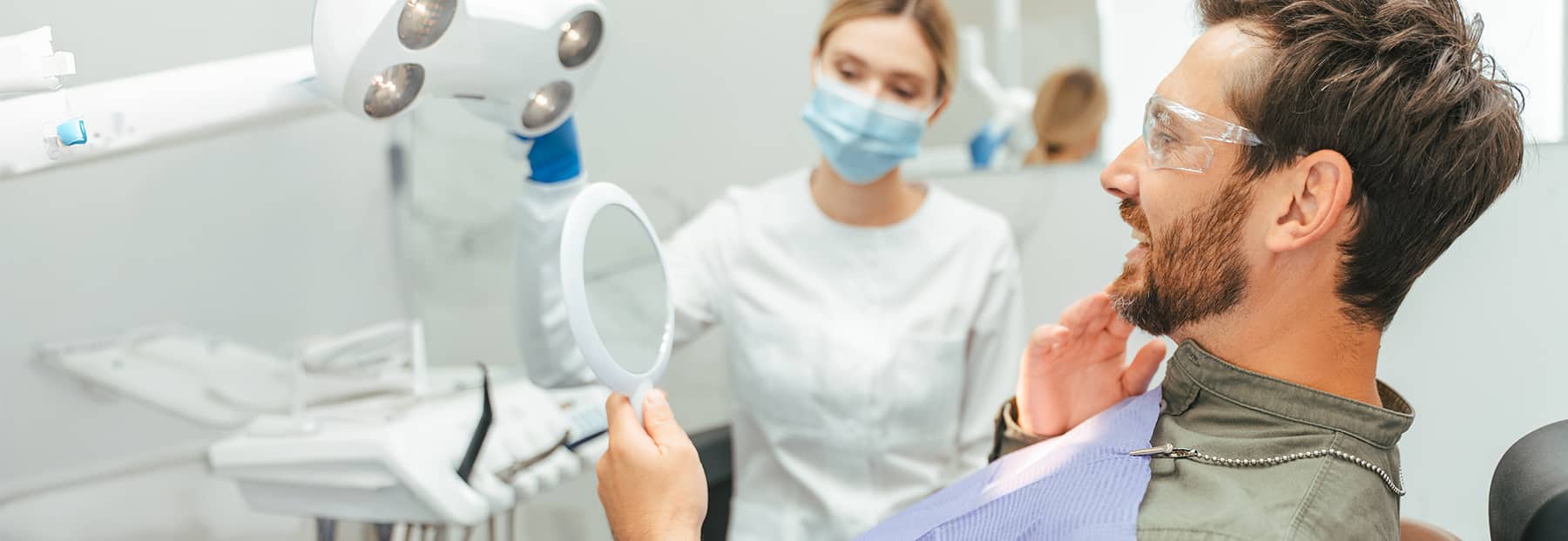 Patient happy to see their new smile after oral surgery.