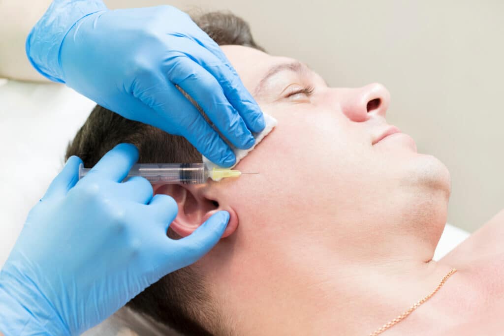 Patient getting facial injections.