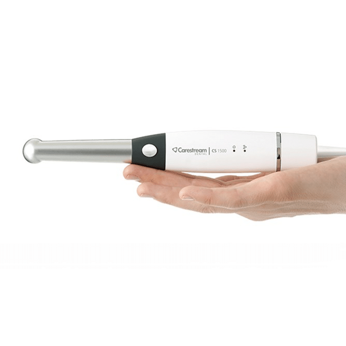 Hand holding intraoral camera on display.